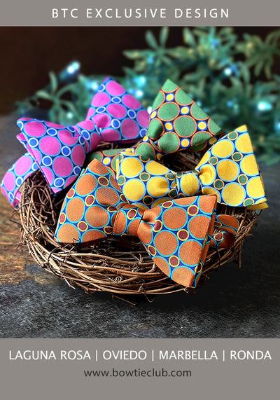 A basket of bow ties in colorful dots and circles