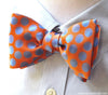 orange and blue woven polka dot bow tie on shirt